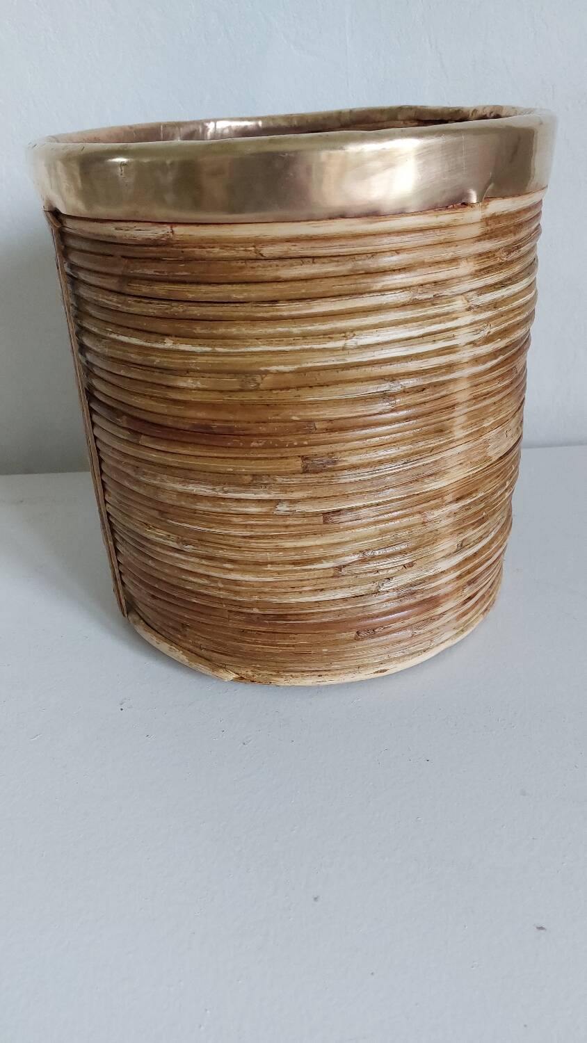 Rattan and brass pot cover