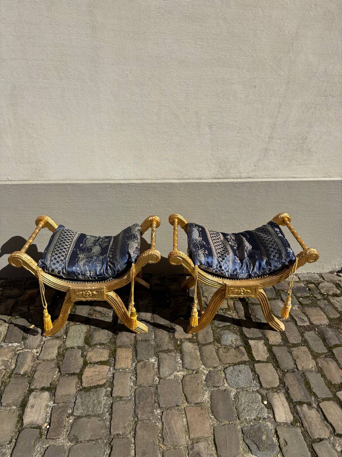 2 wooden footrests with blue cushions