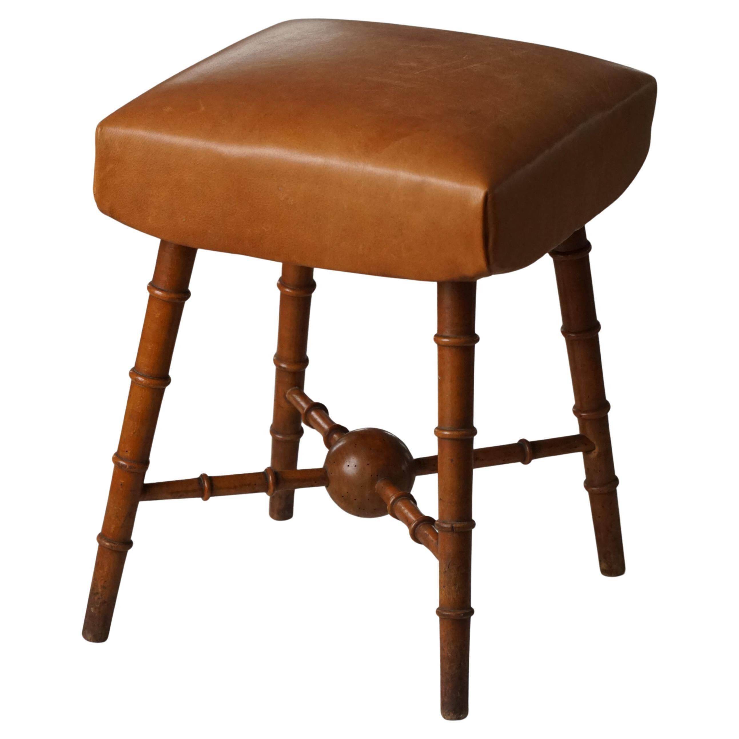 Turned wooden stool with leather seat, mid-20th century, Danish modern.