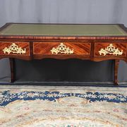 Louis XV style desk. Rosewood veneer, gilt bronze decoration, leather.
