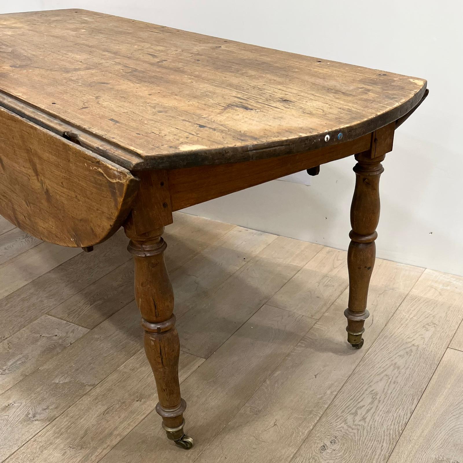 Louis Philippe wood dining table with shutters and casters