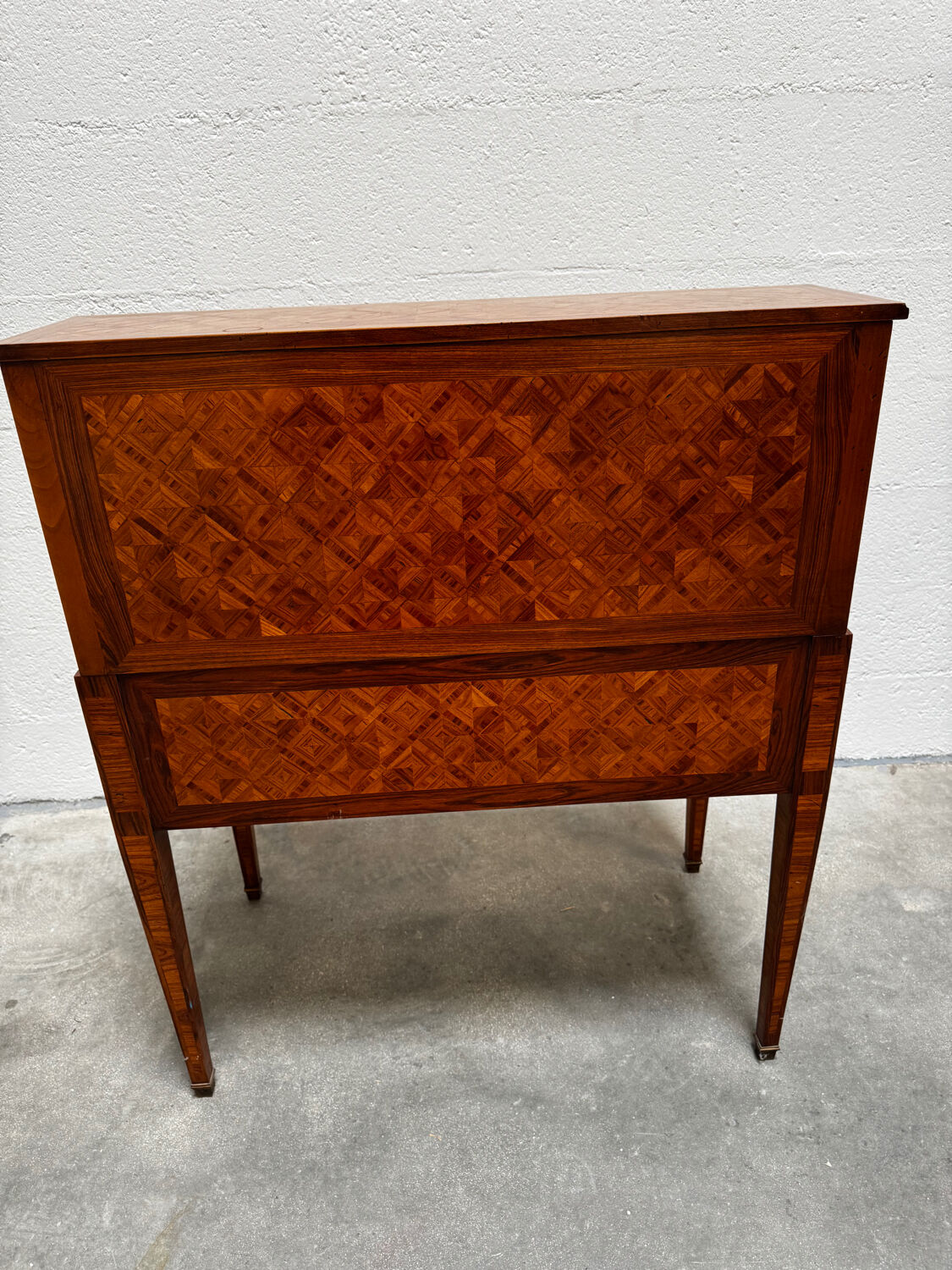 Cylinder desk with marquetry featuring a crosshatch design.