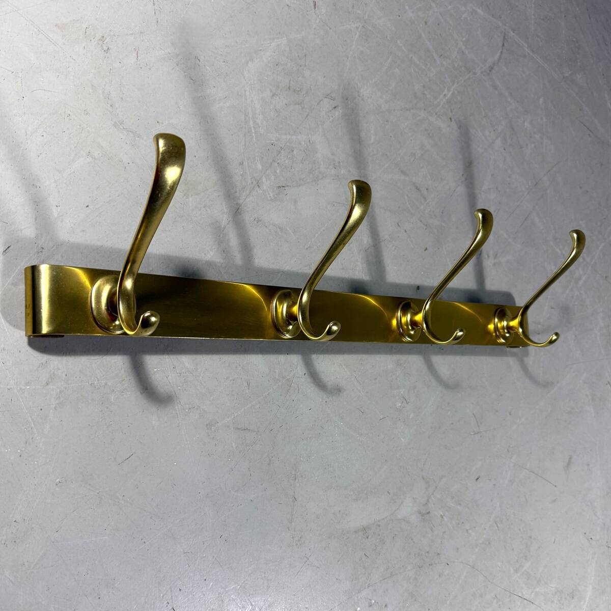 Gold coloured aluminium wall coat rack 1960’s