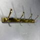 Gold coloured aluminium wall coat rack 1960’s