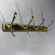 Gold coloured aluminium wall coat rack 1960’s