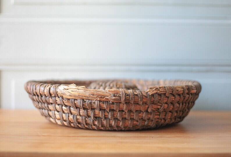 Old wicker basket, straw and bramble, woven basket, countryside, chalet, kitchen, interior decoration.