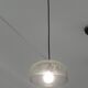 Modern suspended lamp in cracked blown glass, minimalist design.