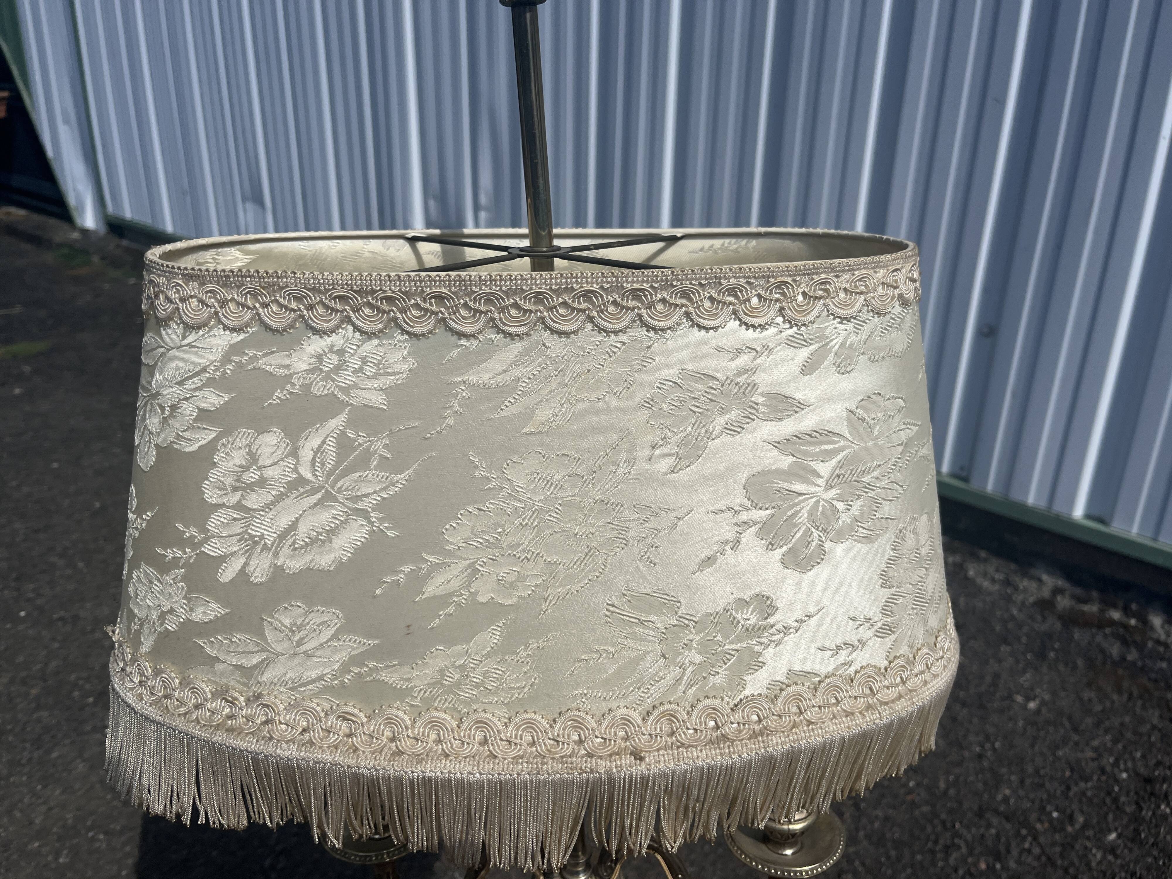 Two-armed hot water bottle lamp in silver metal with fringed fabric shade