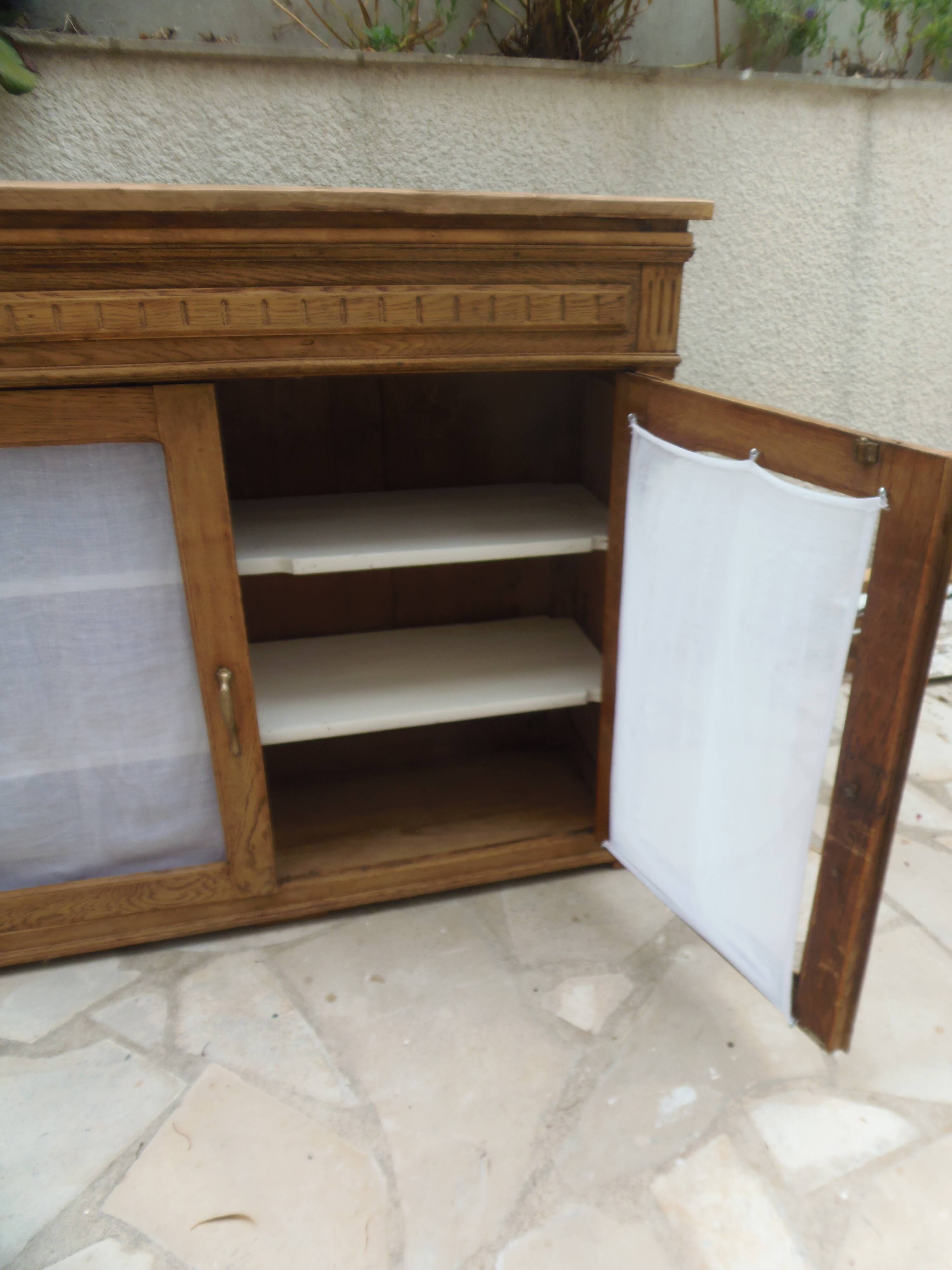 Antique wooden sideboard, fabric doors and pearl grey shelves.