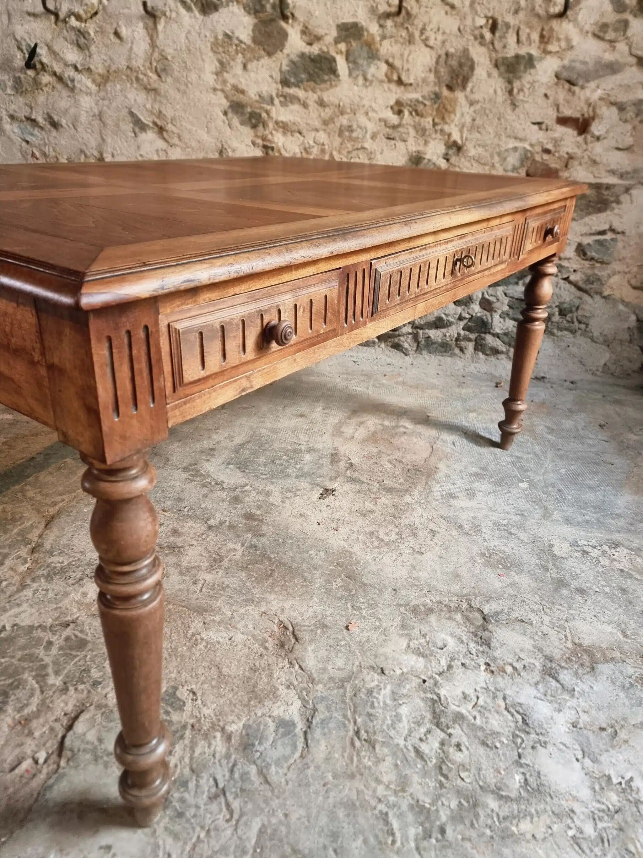 Antique French walnut table with six drawers, parquet top, early 20th century.