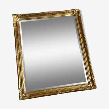 Beveled mirror with golden wood frame