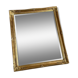 Beveled mirror with golden wood frame