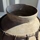Very large light grey terracotta pot with handles and rattan crossbars.