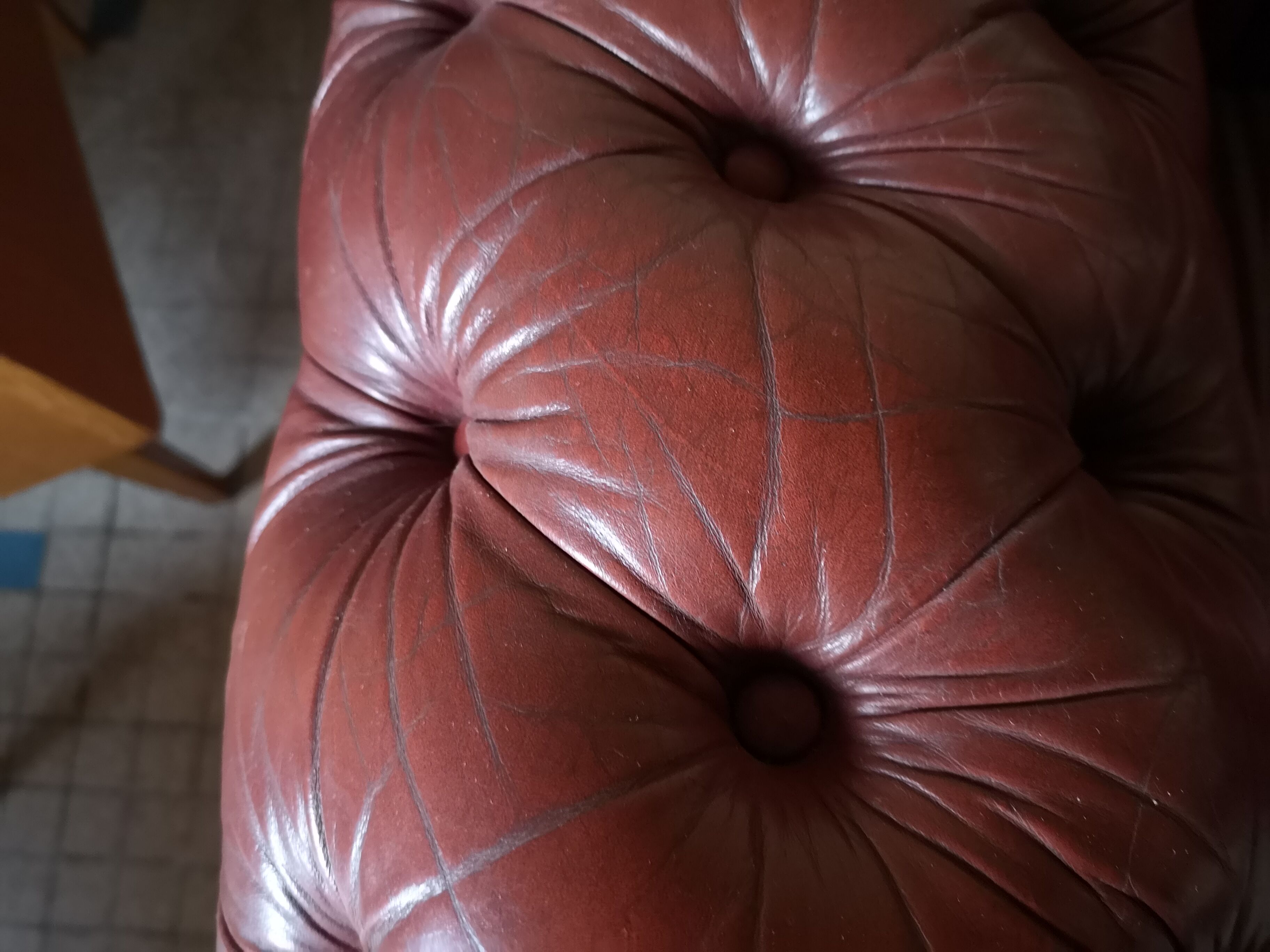 Old red leather Chesterfield sofa