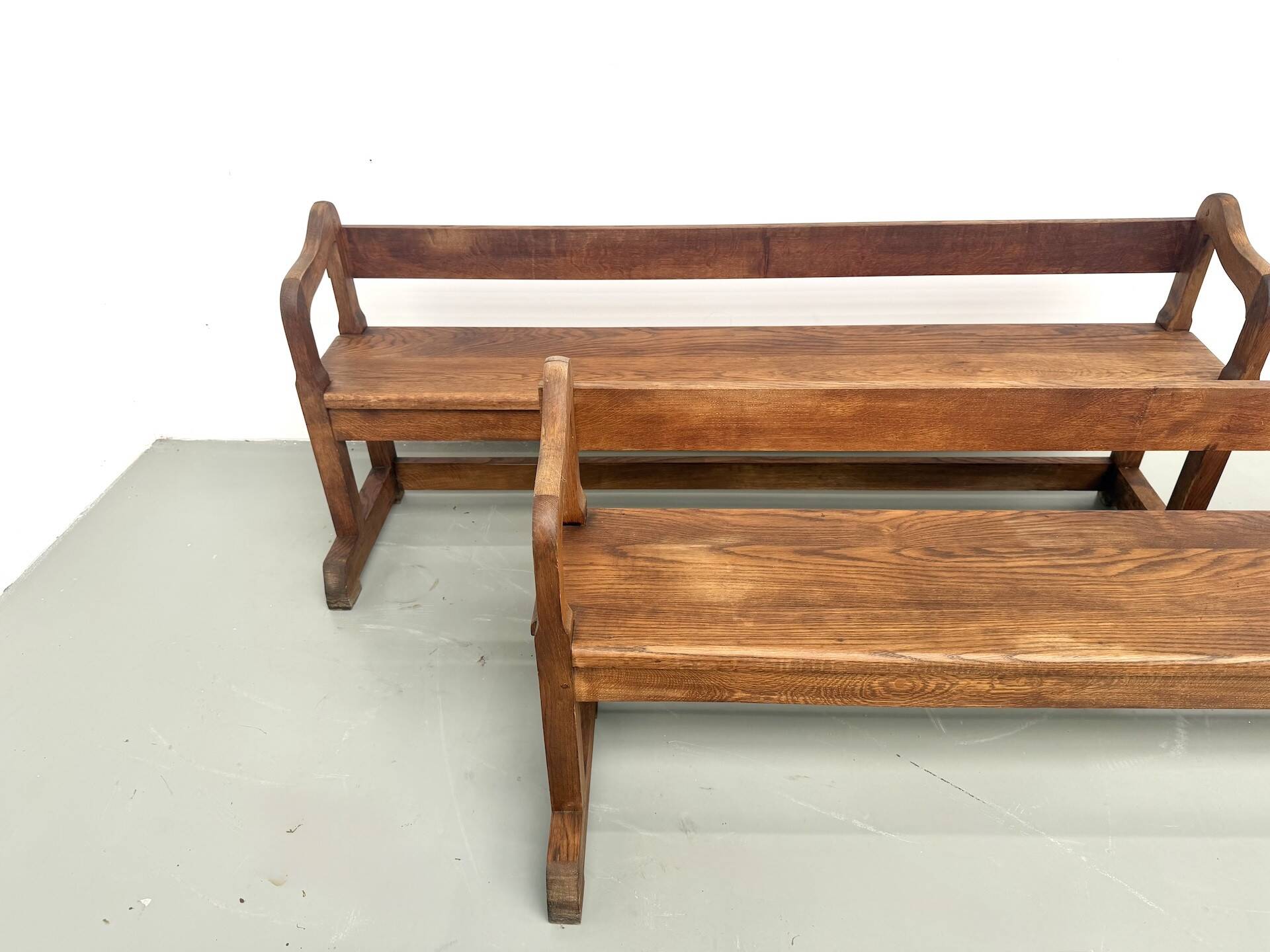 Pair of communal benches in solid oak, 1950s.