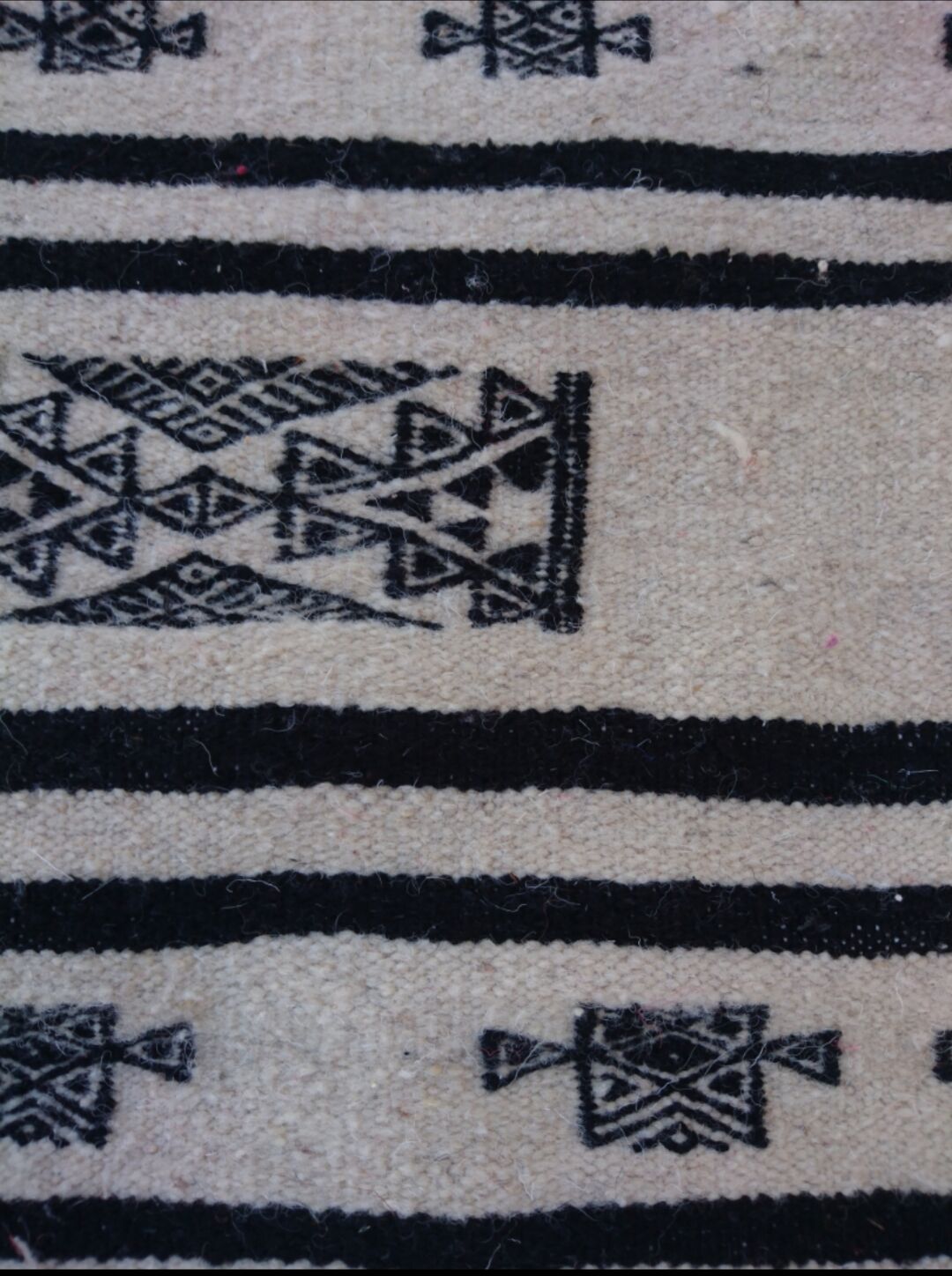 Beige and black handmade carpet, 110x55cm
