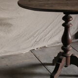 Old oval pedestal table in raw wood