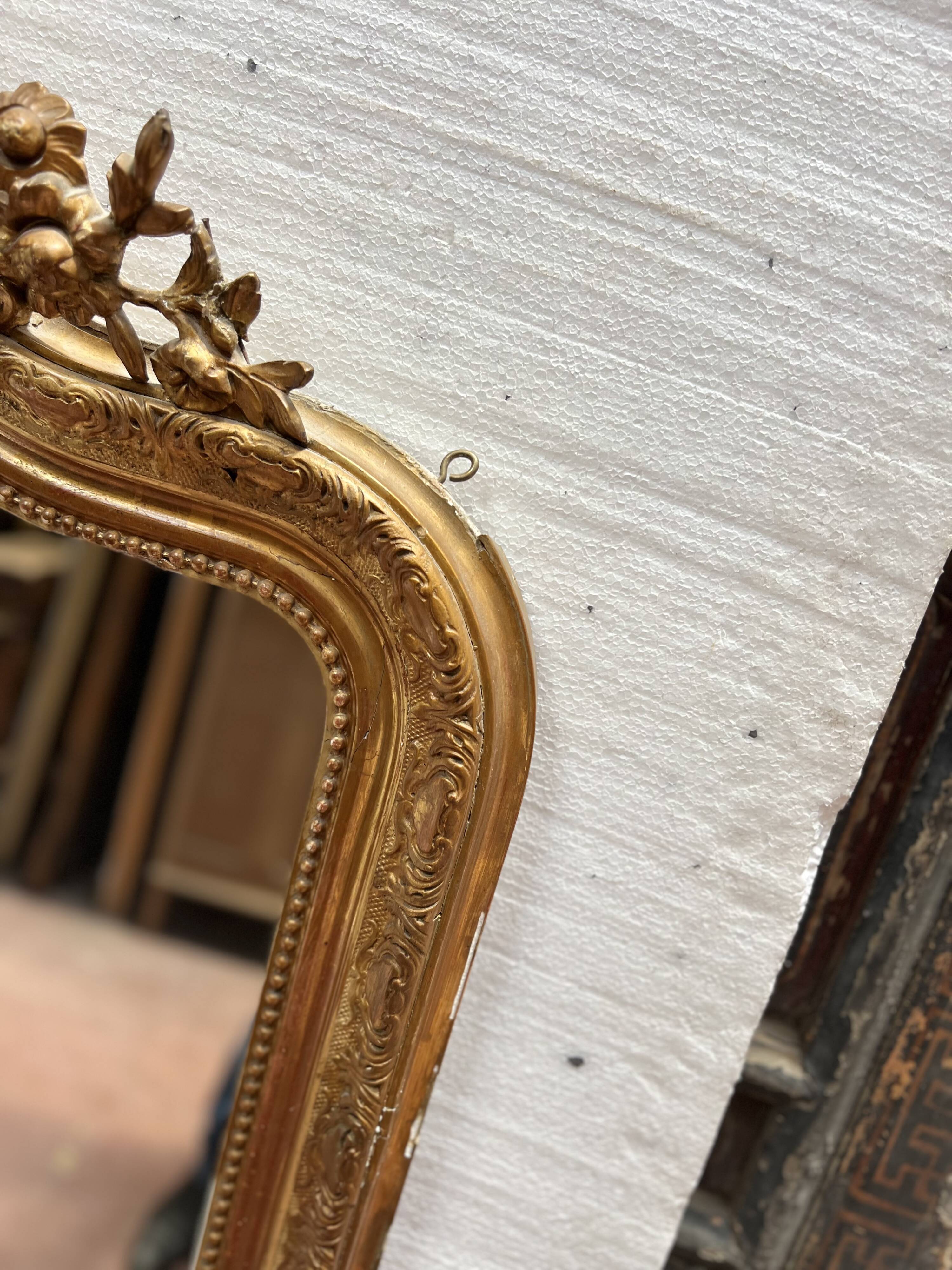 Louis XV style mirror in gilded wood and stucco, 20th century.