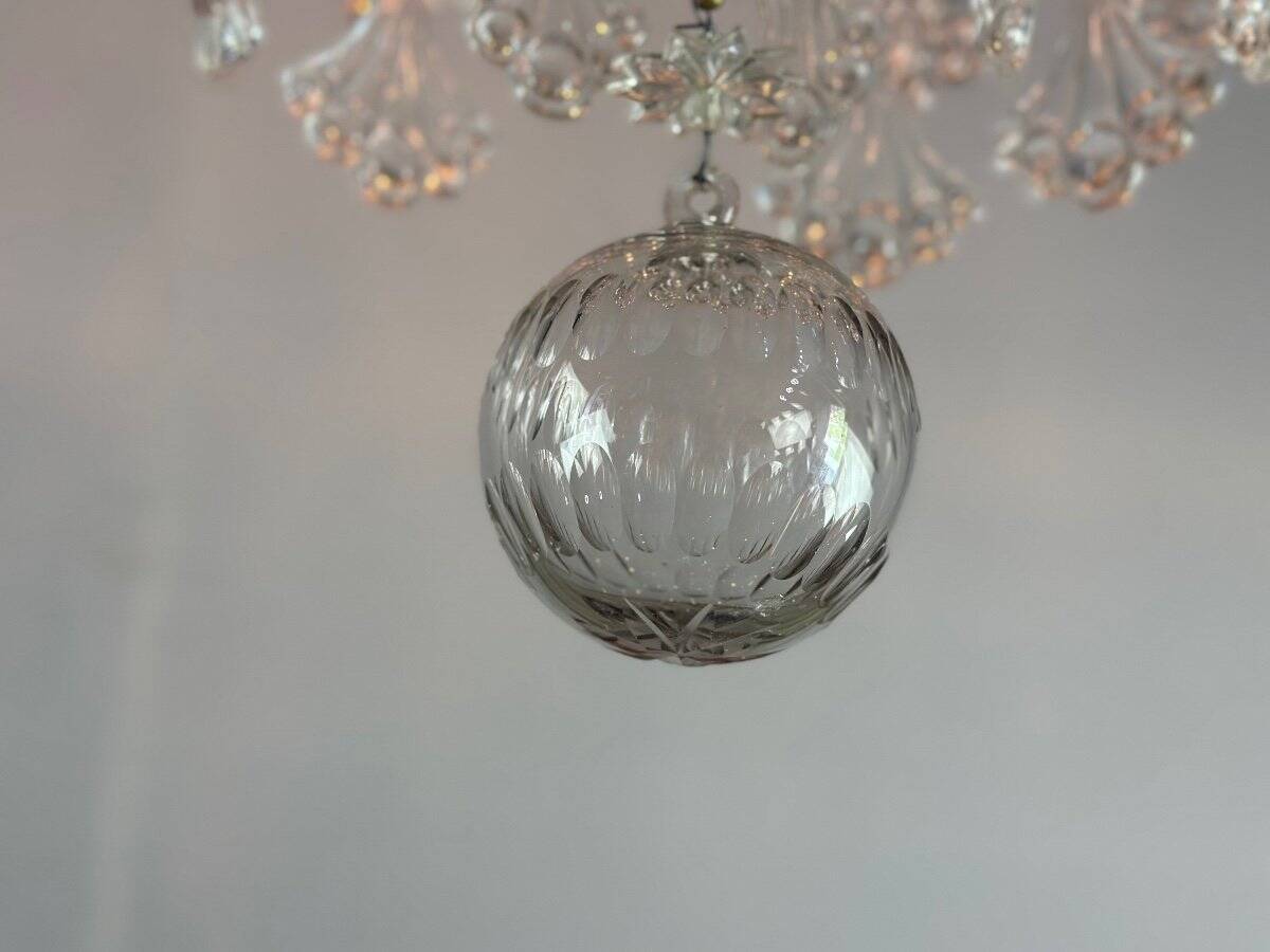 Bronze cage chandelier adorned with molded glass pendants in the shape of peacock feathers, circa 1800