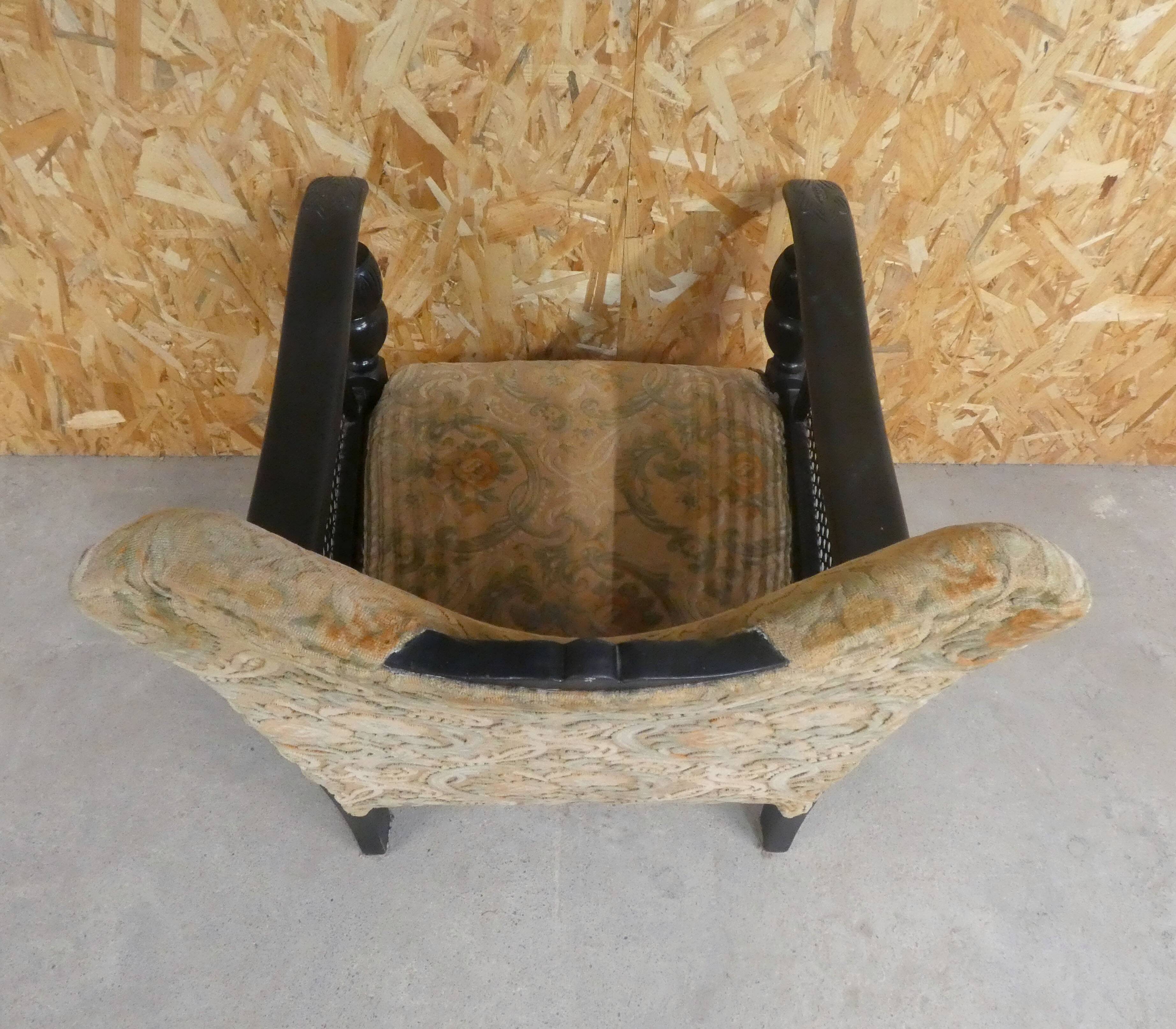 Old armchair upholstered in velvet, carved and caned wood