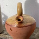 Gargoulette or old jug in yellow glazed terracotta