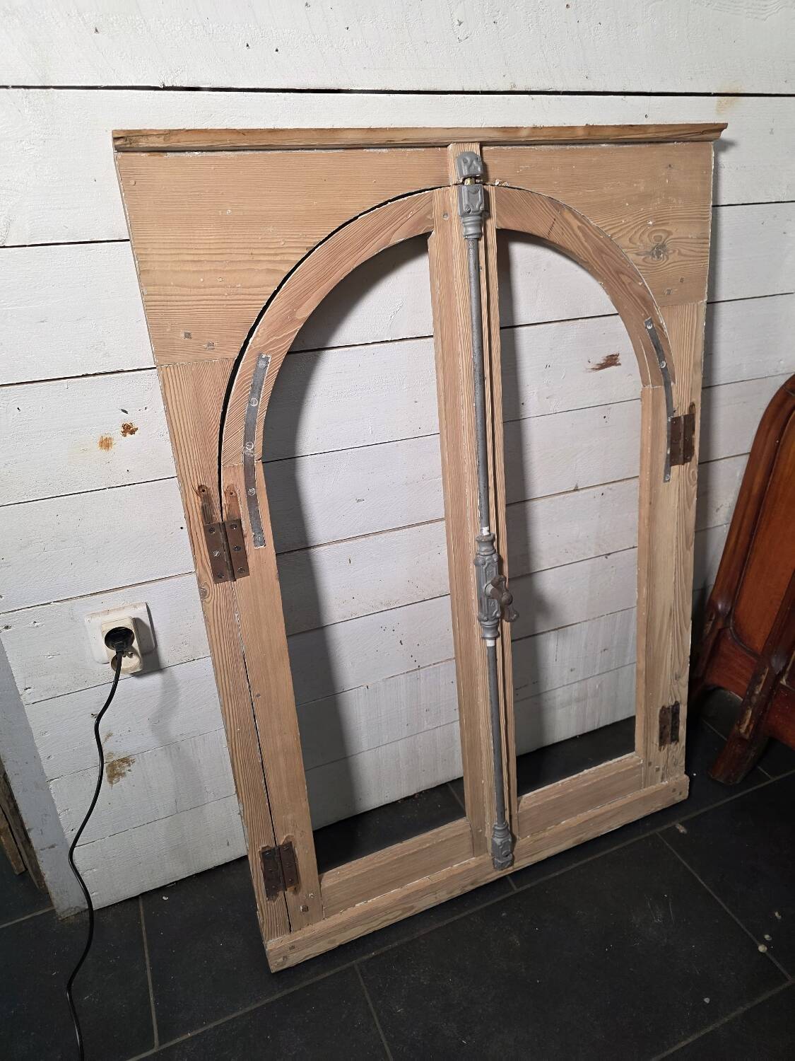 Old arched window made of fir wood
