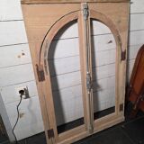 Old arched window made of fir wood