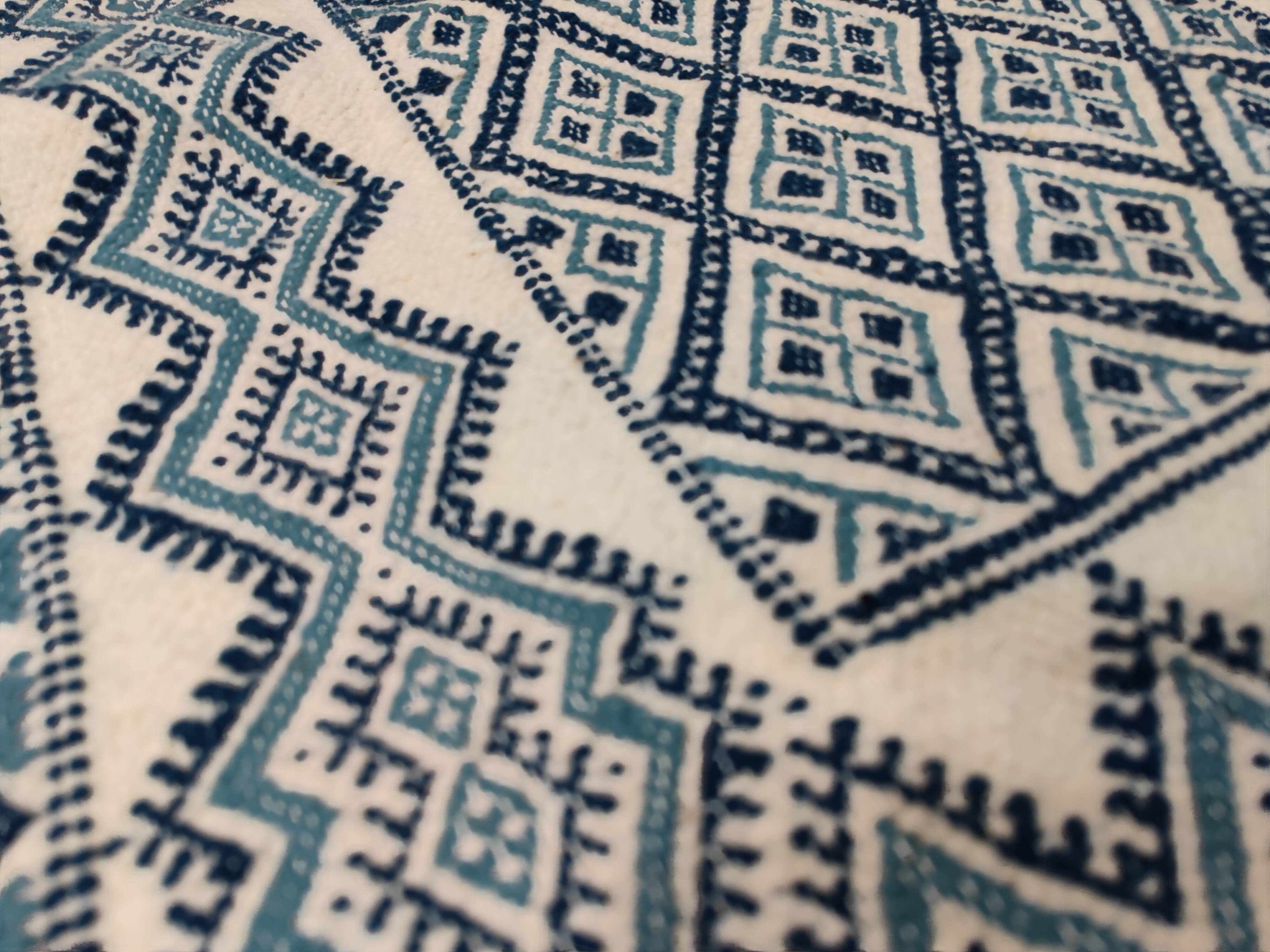 White and blue hand-woven rug in natural wool