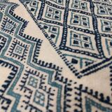 White and blue hand-woven rug in natural wool