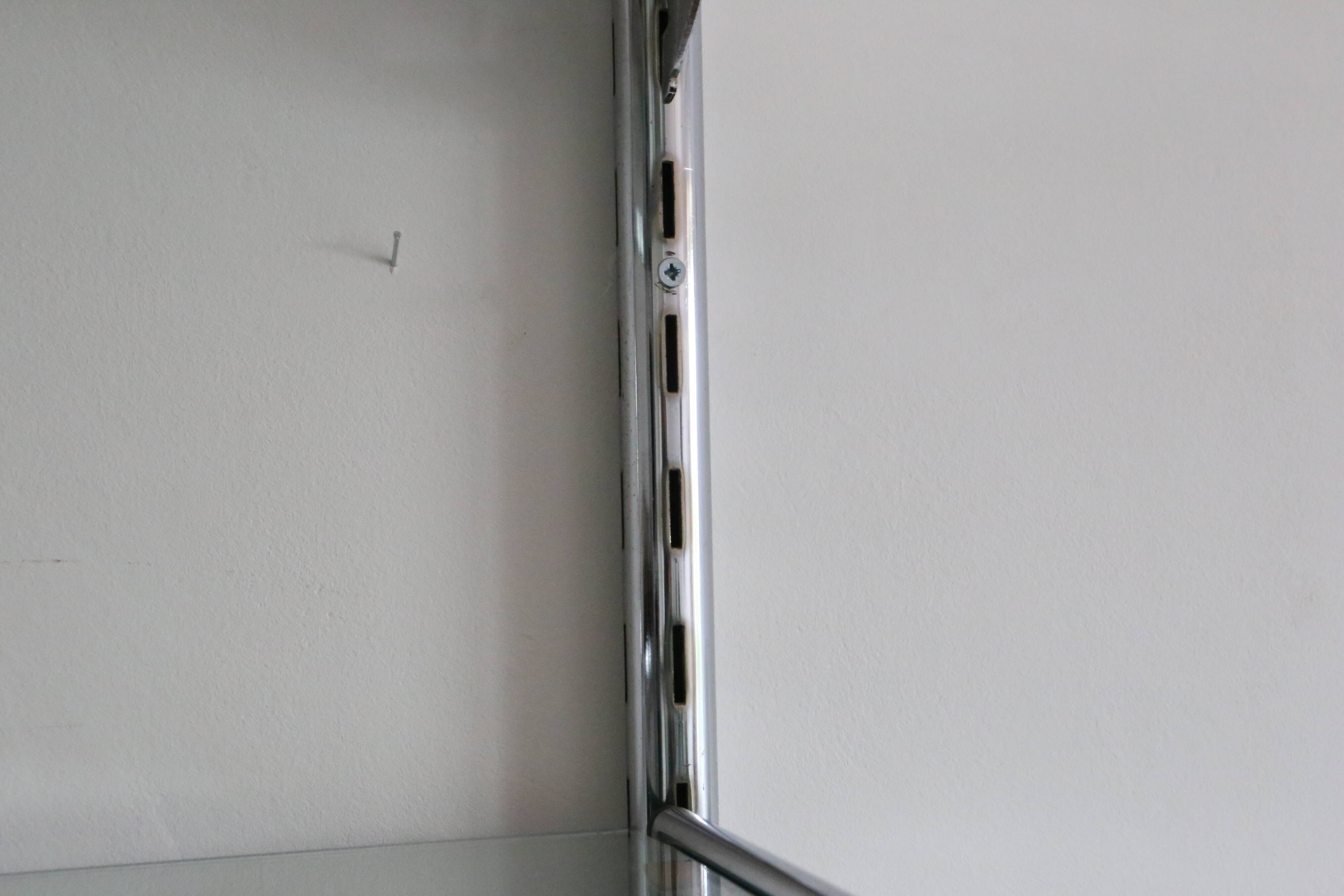 Chrome and glass wall shelf, circa 1960