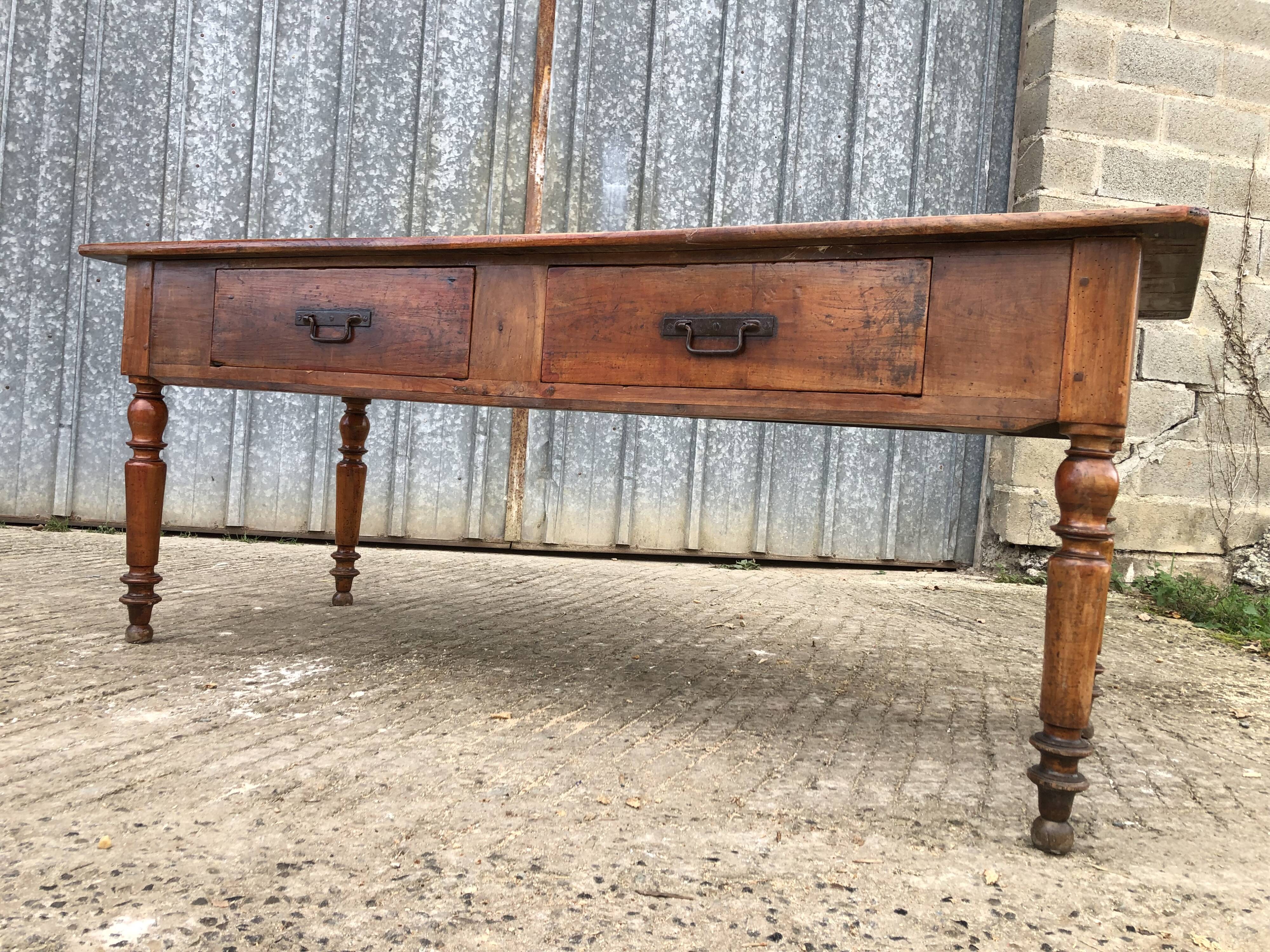 Old farmhouse table in solid cherry wood with 2 front drawers.
