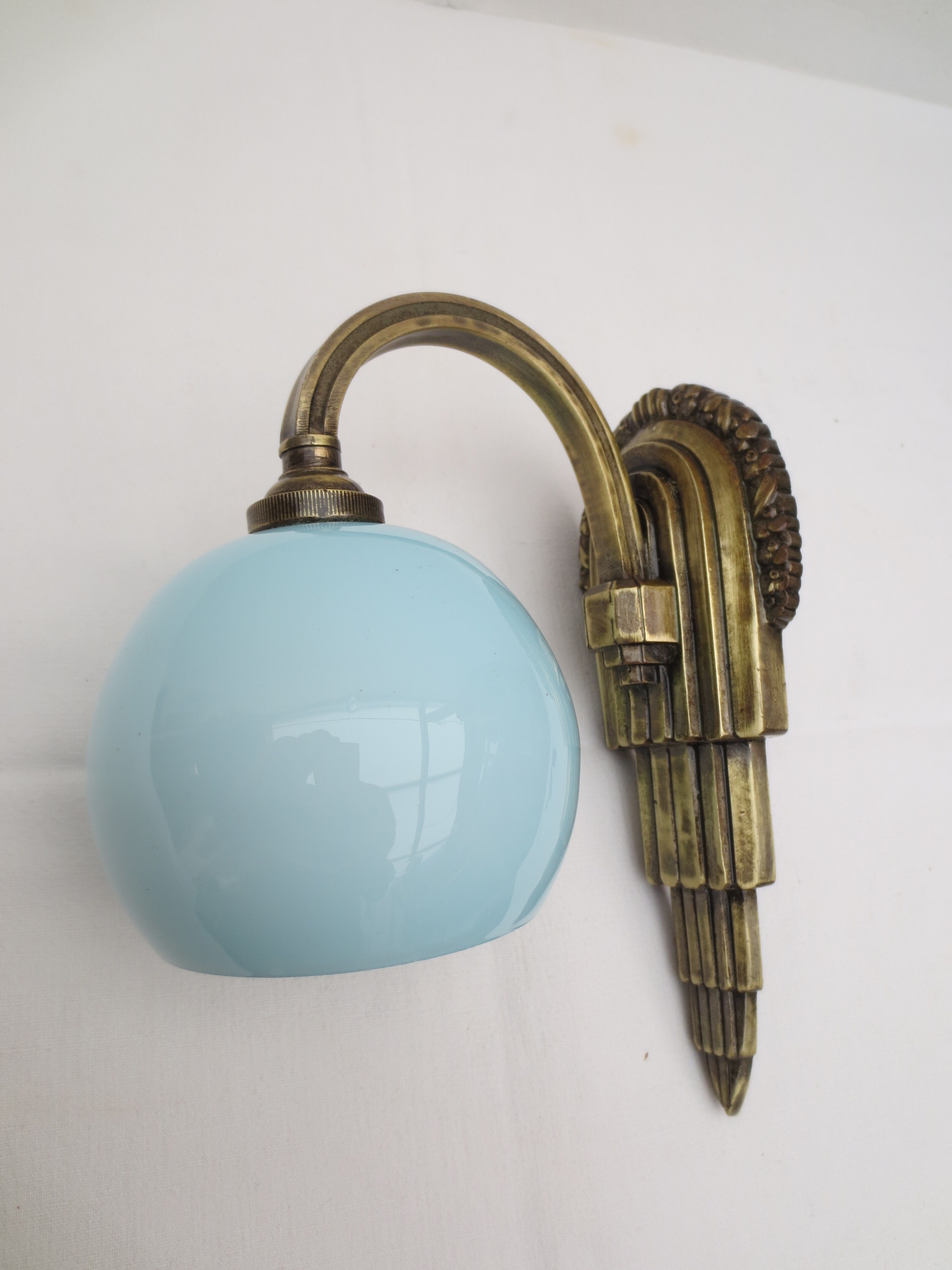 Art deco wall lamp in brass and soft blue opaline globe