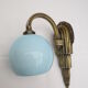 Applique art déco en laiton  et globe opaline bleu doux