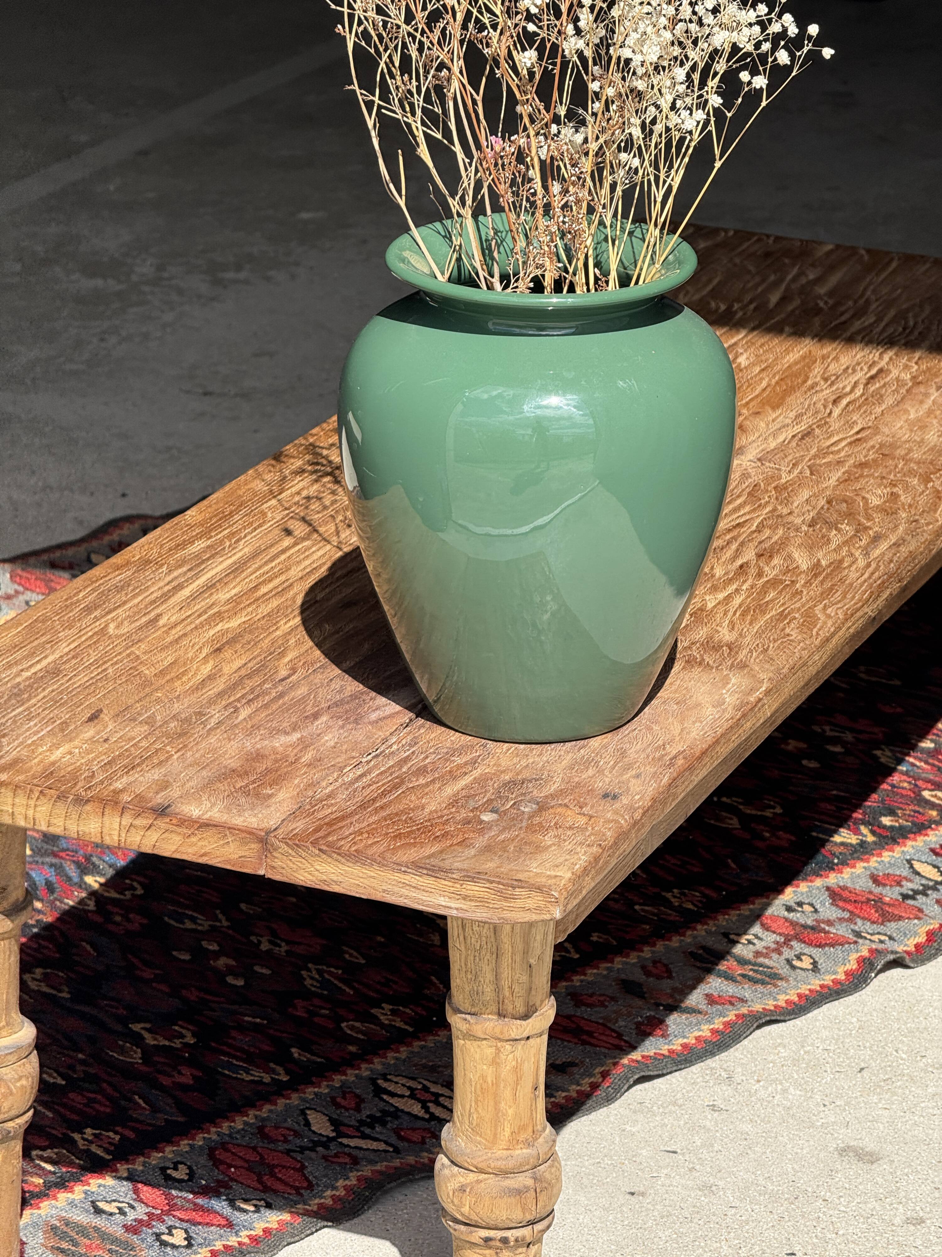 Brown Indonesian teak coffee table, with a border and cylindrical legs H40 L103.