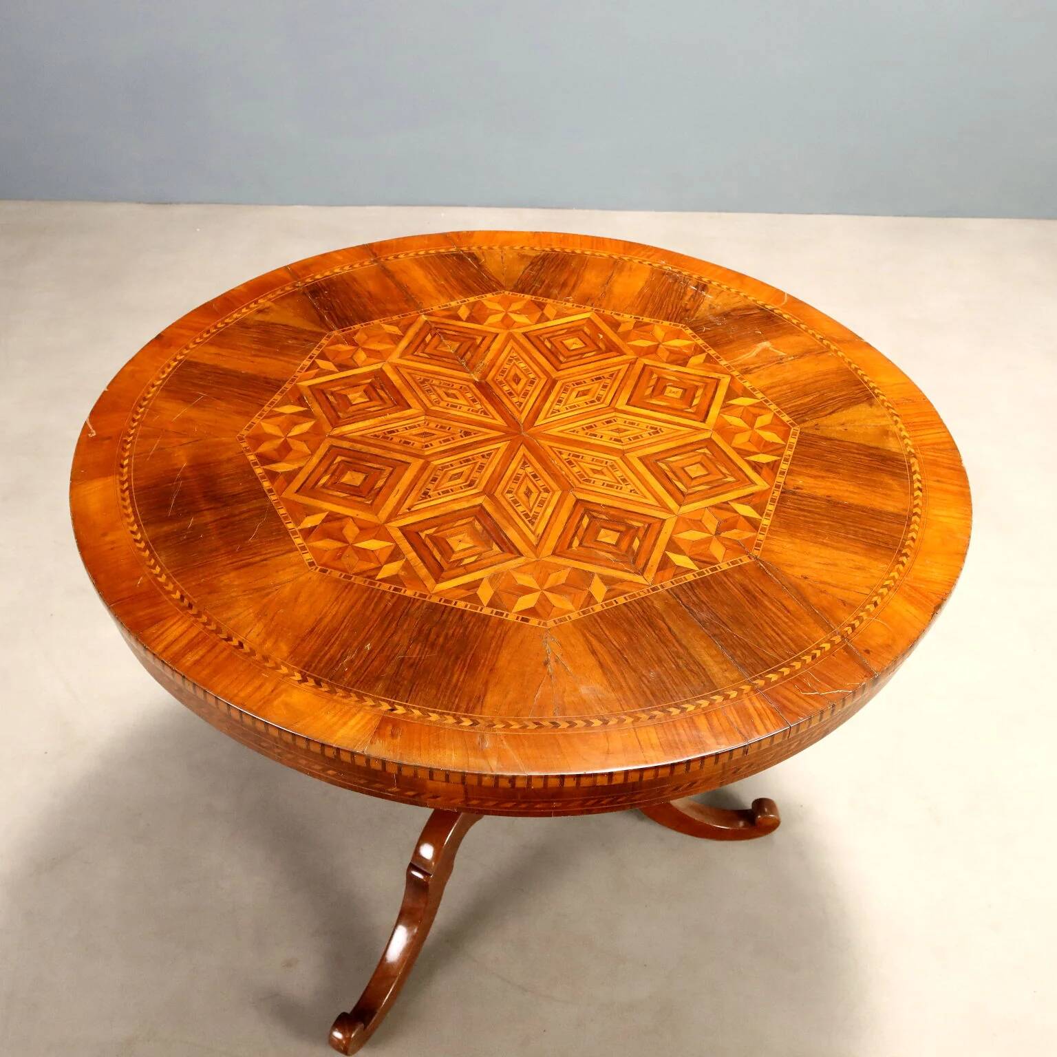 Antique round walnut table with a baluster central leg, Italy, 19th century.