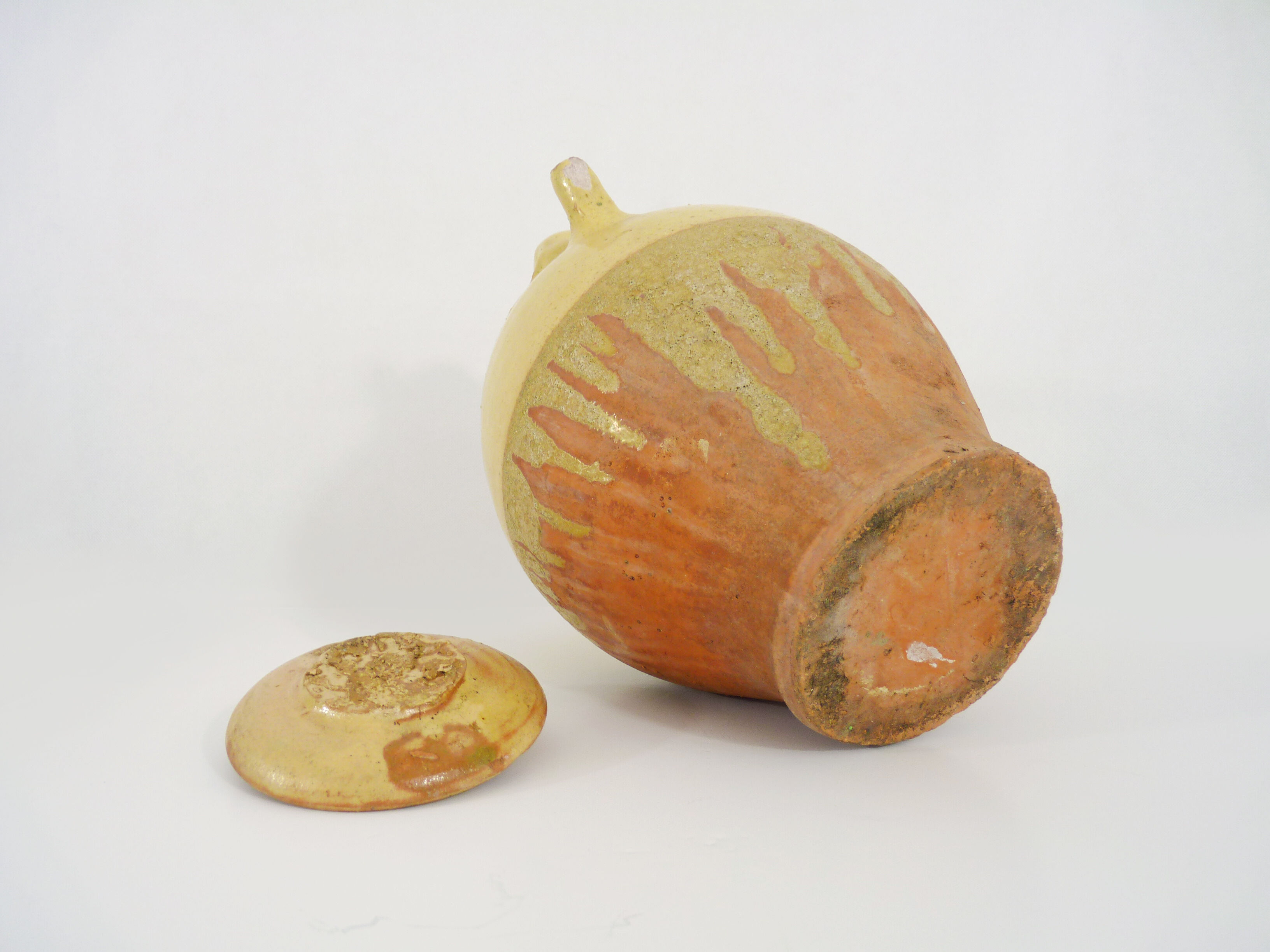 Old jug, chevrette, water pitcher in glazed yellow sandstone. Early twentieth century