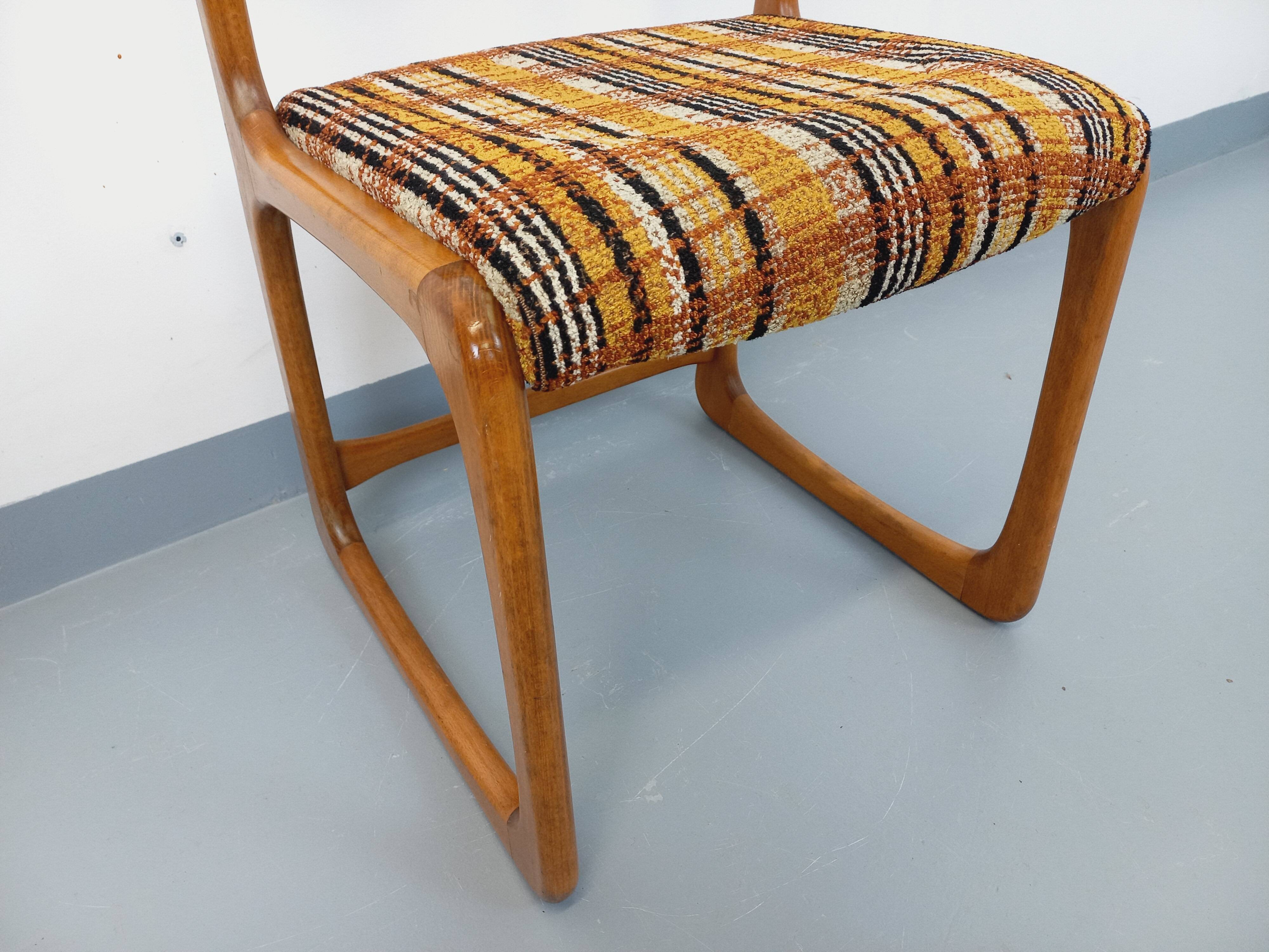 Vintage sled chair by Baumann in wood and wool fabric.
