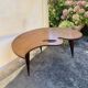 Mid-century coffee table with a palette shape and splayed legs.