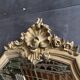 Antique bevelled baroque mirror in patinated wood