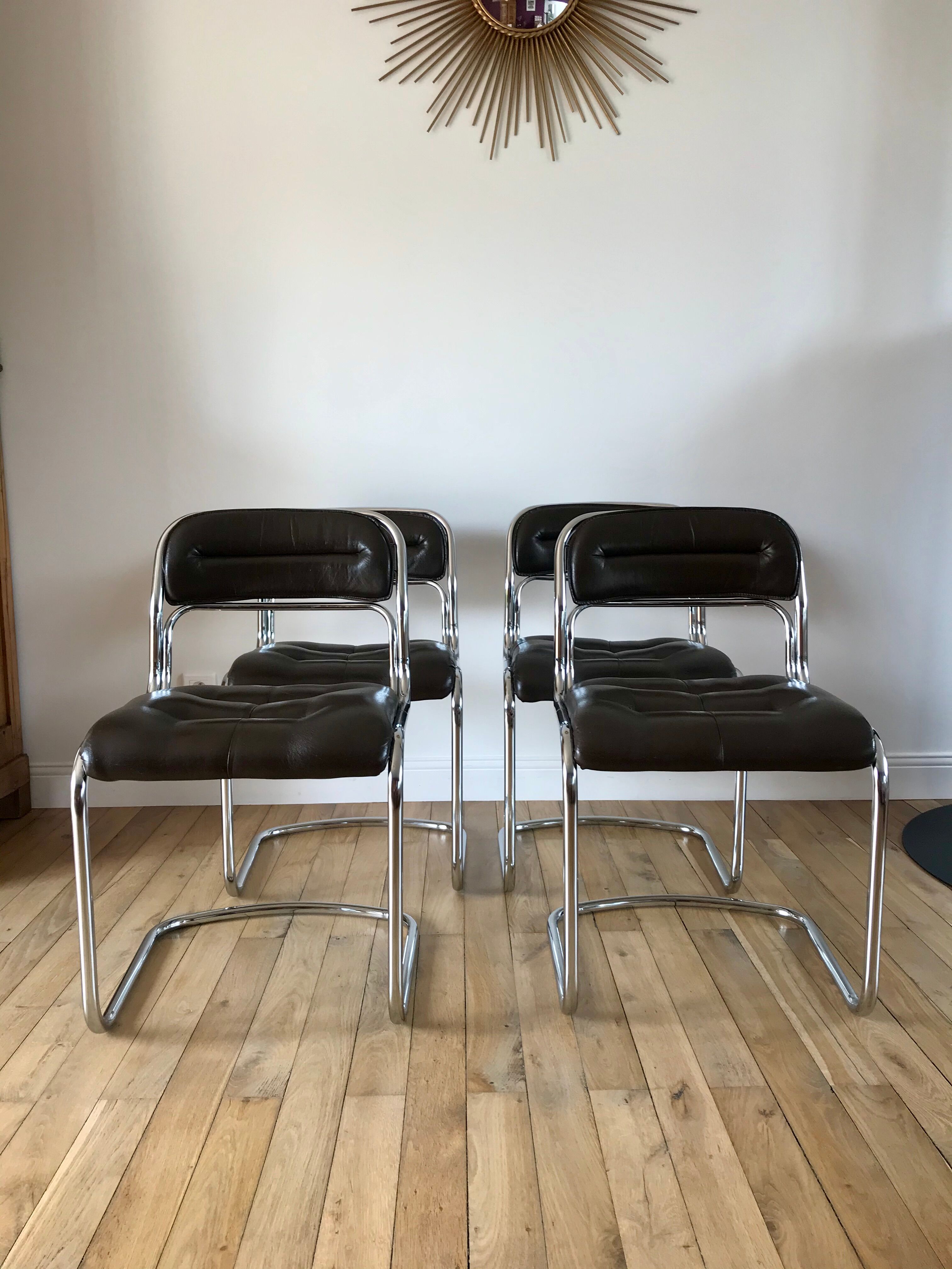 Set consisting of a table in chrome and smoked glass and its 4 tubular chairs in chrome and skaï a