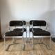 Set consisting of a table in chrome and smoked glass and its 4 tubular chairs in chrome and skaï a