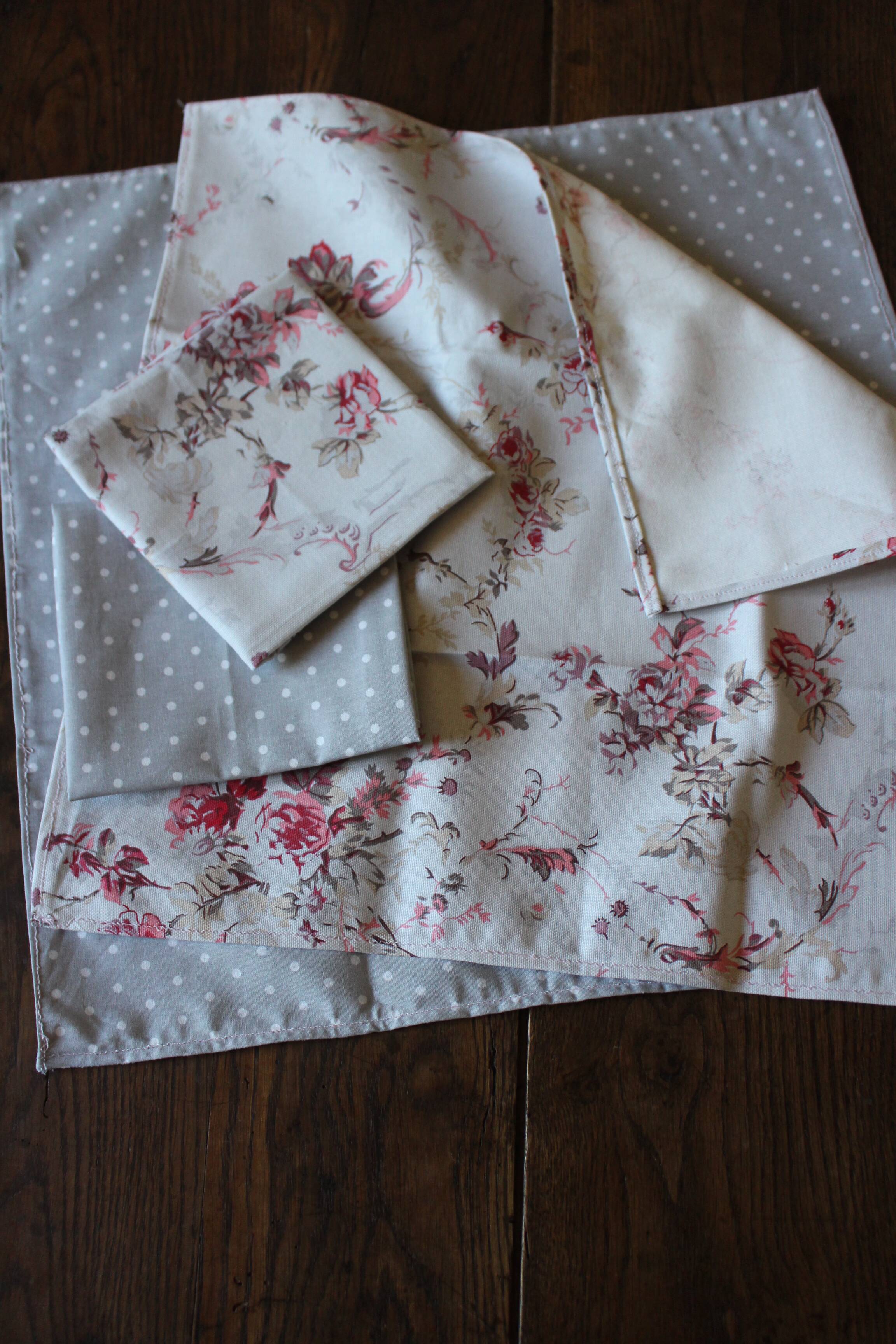 A set of 8 gray blue napkins with pink flowers and polka dots