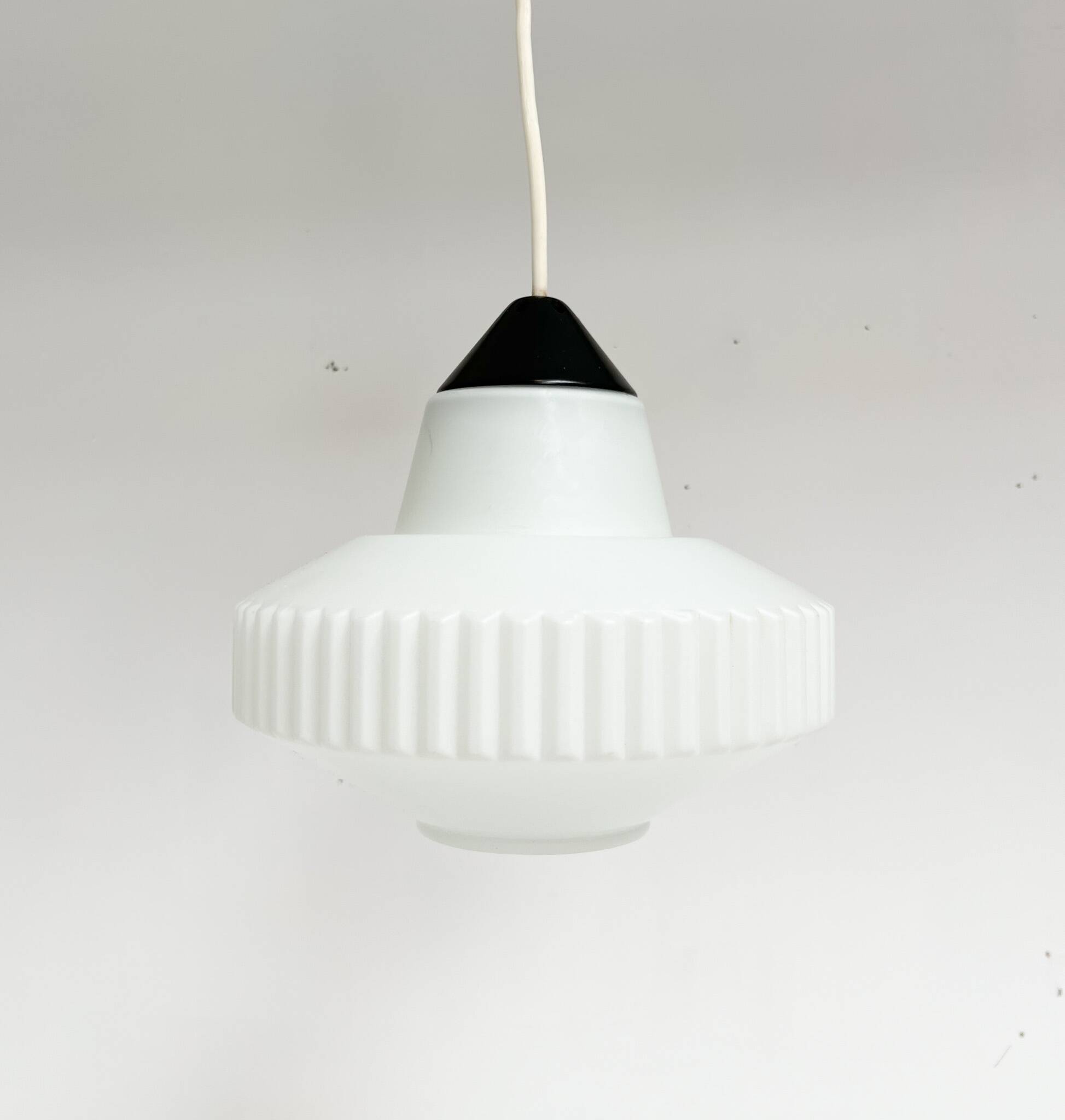 This decorative opal glass lamp is a design by Louis Kalff for Philips. The