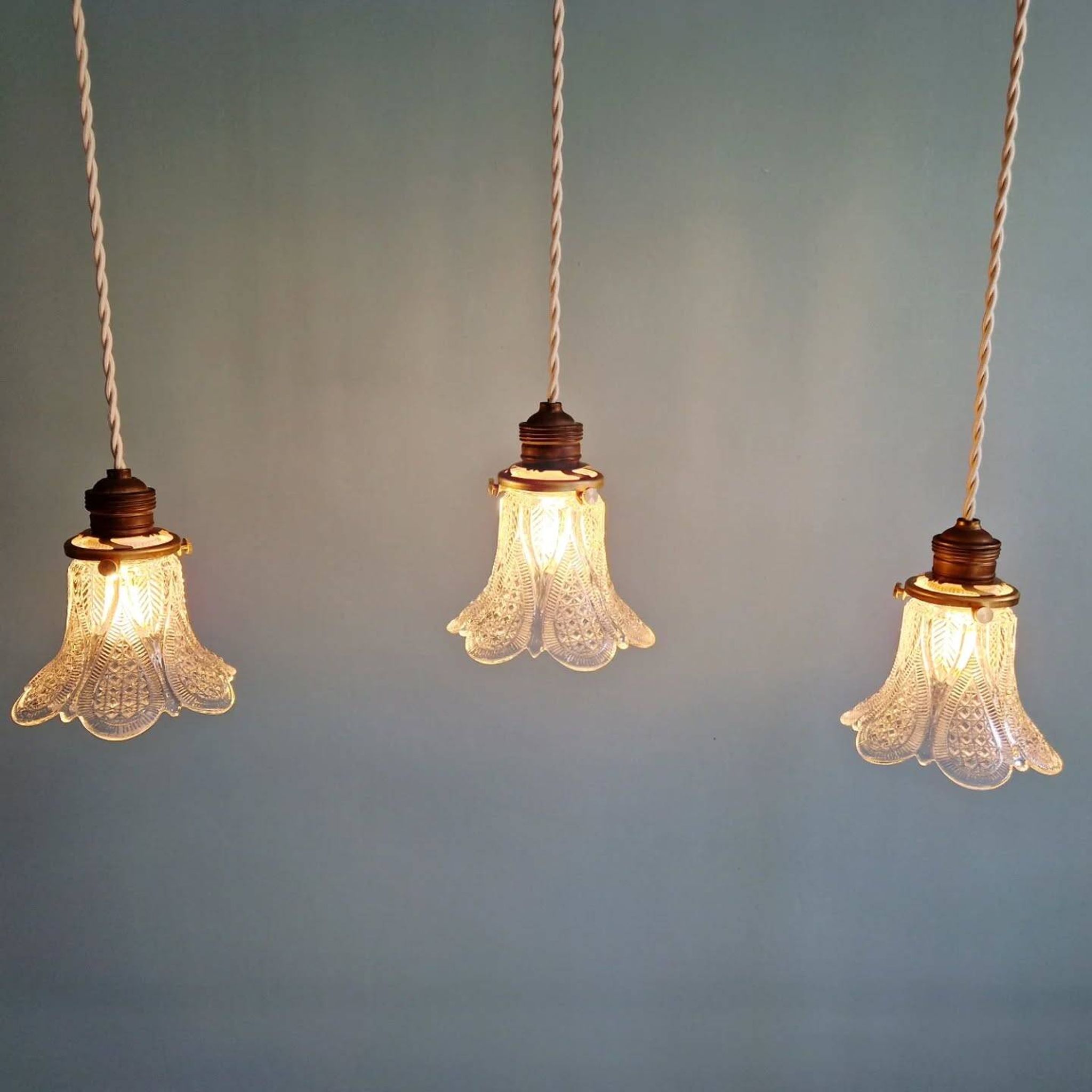 Art Deco trio of pendant lights/table lamps in clear glass, 1920s-30s.