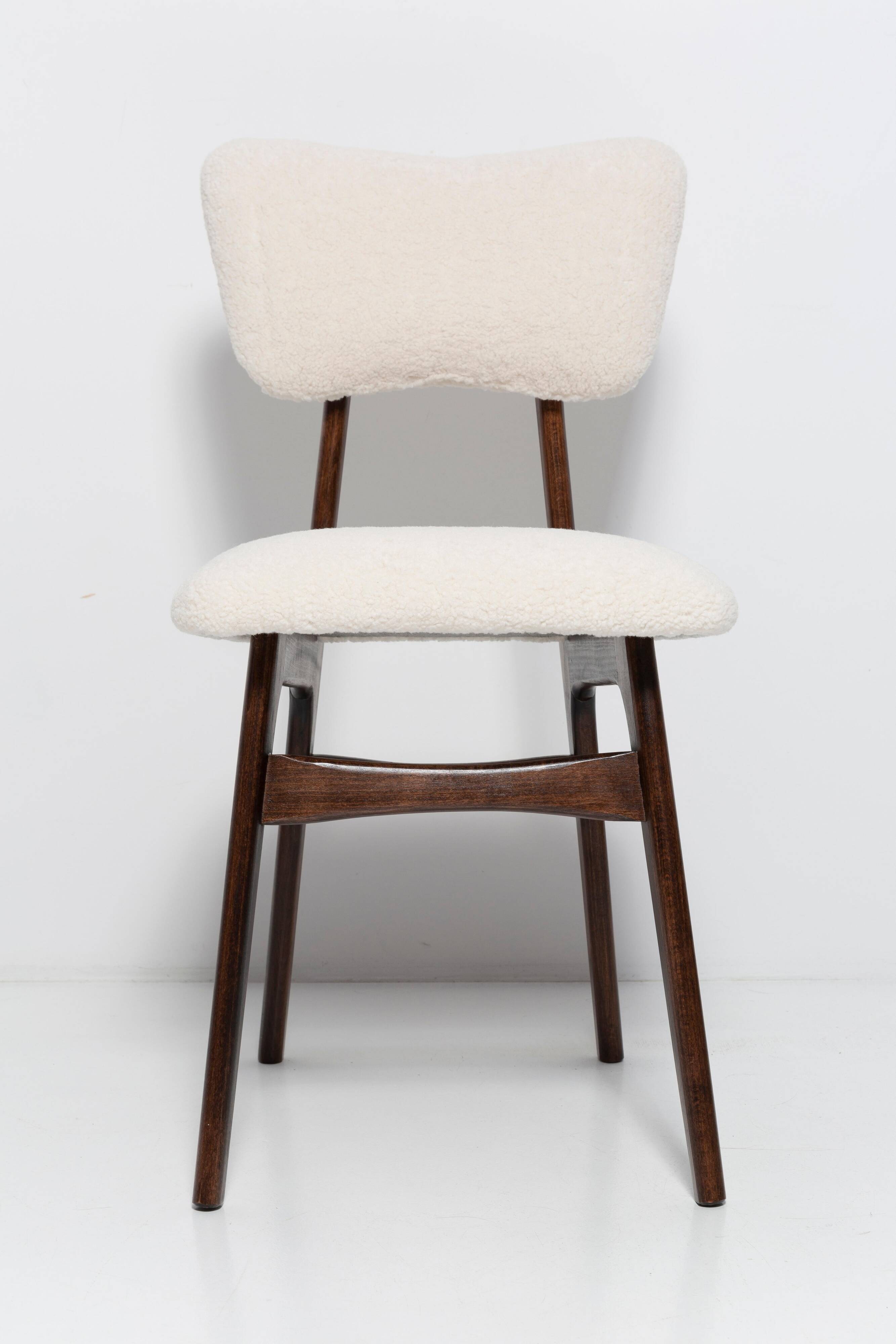 20th-century walnut and light cream boucle butterfly chair, Europe, 1960.