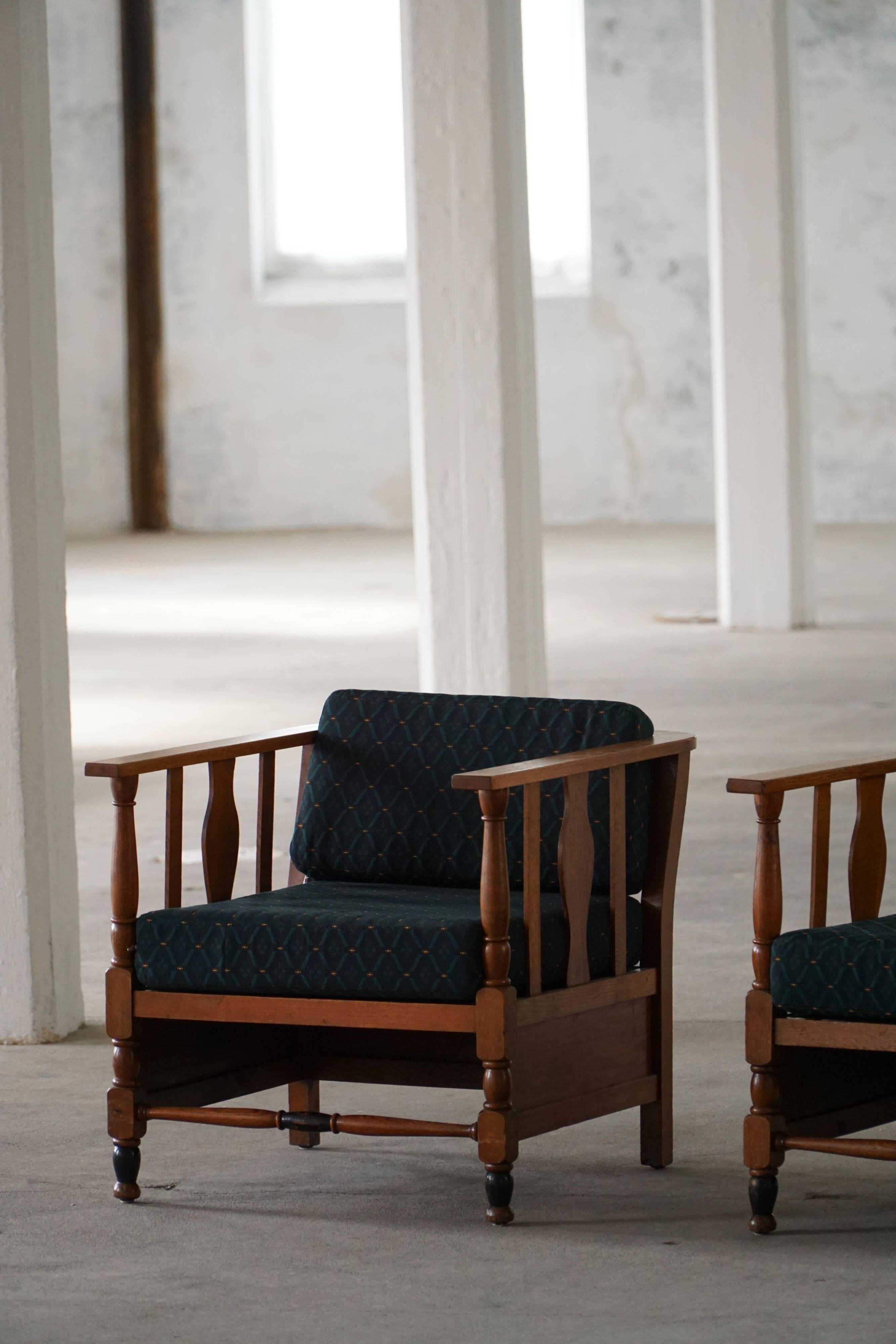 Art Nouveau, pair of oak lounge chairs, reupholstered in style fabric, 1920s.