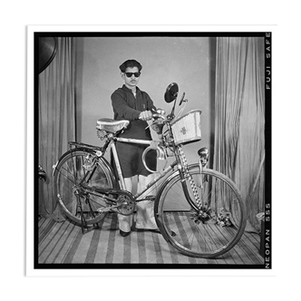 Photograph of an Indian posing with his bike