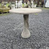 Cement garden table with trunk-shaped foot