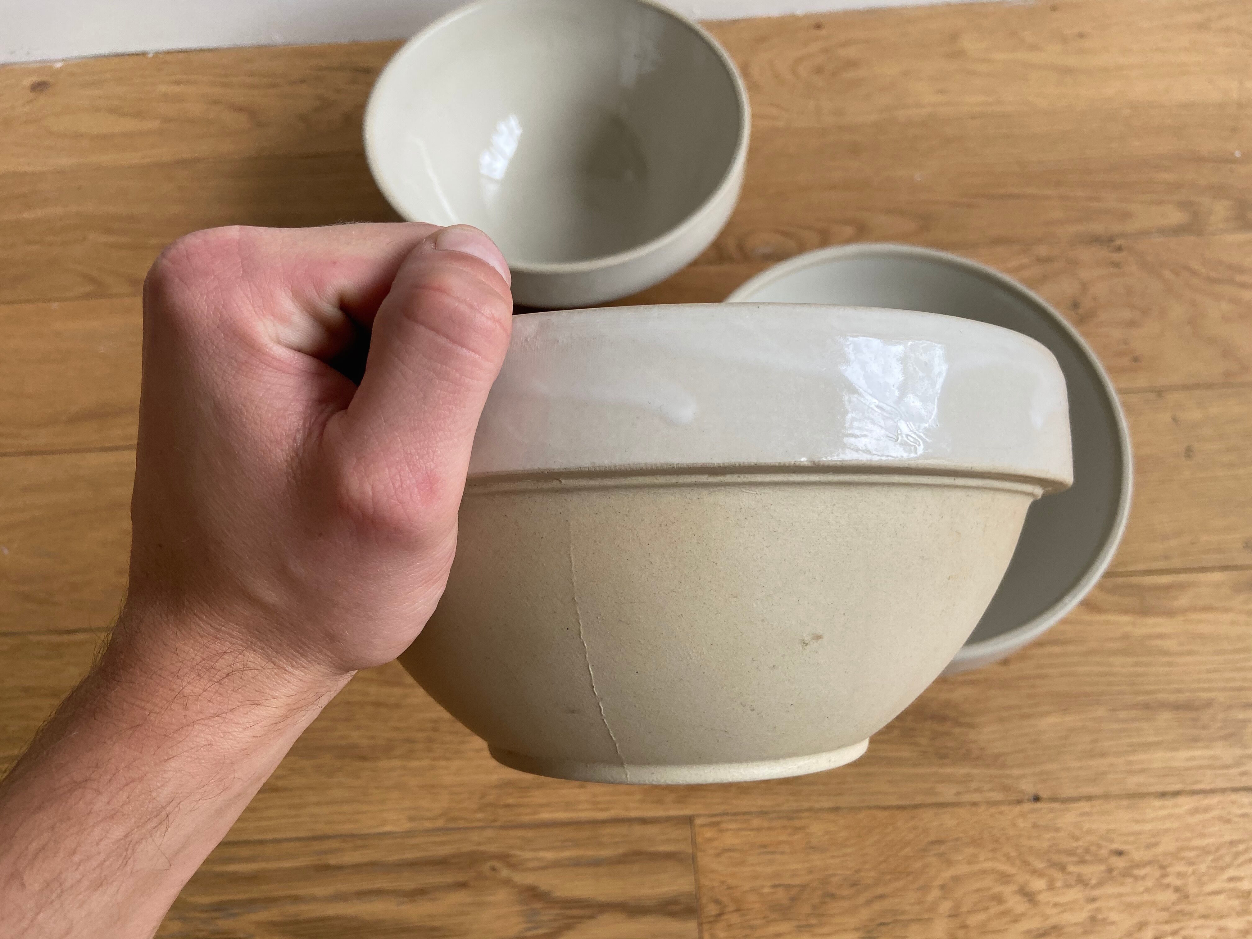 Trio of beige enamelled sandstone bowls