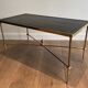 Neoclassical brass coffee table with a black leather top and golden borders from Maison Jansen.